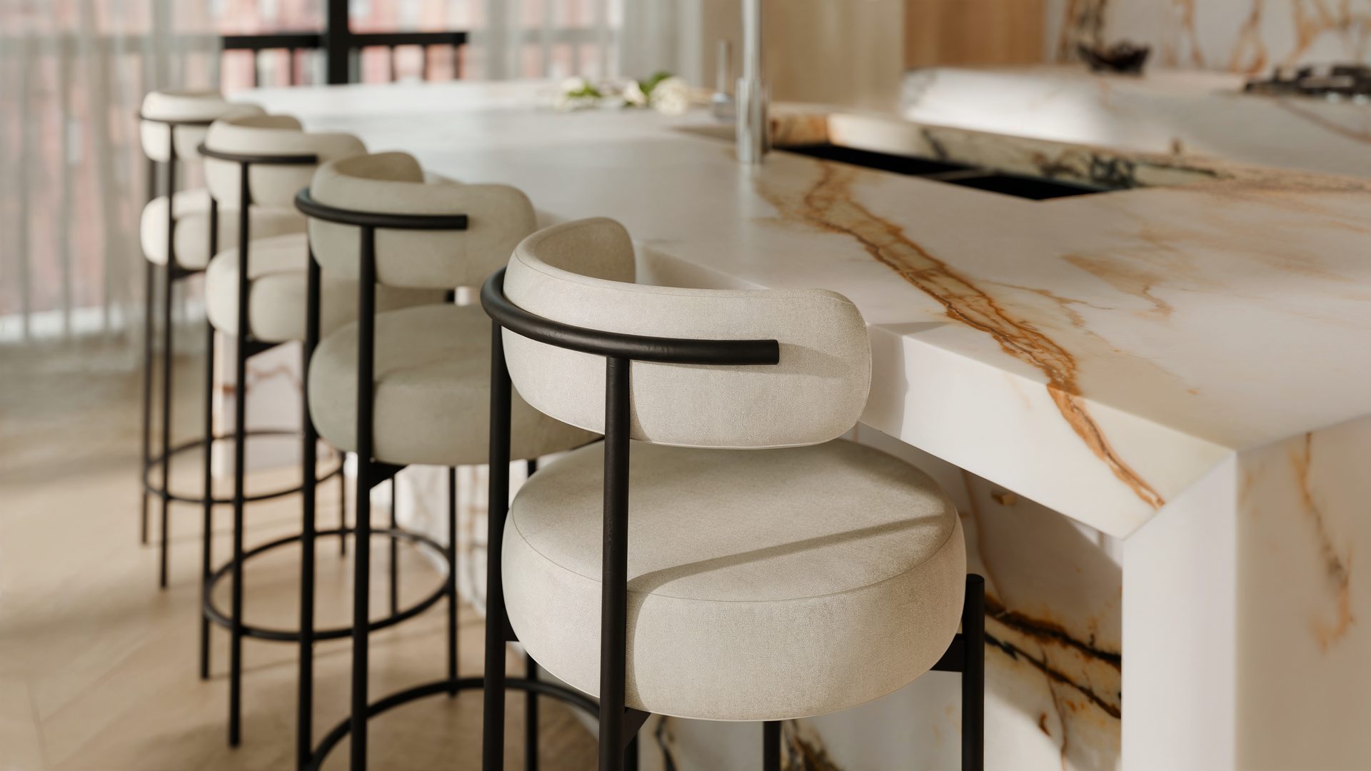 Bar stools at a marble kitchen island